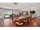 Spacious dining room features a large wooden table and seating for many guests with waterfront view at 690 Osceola Ave # 604, Winter Park, FL 32789