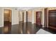 Open hallway with hardwood floors, built-in bookshelves, and doorways leading to other rooms at 690 Osceola Ave # 604, Winter Park, FL 32789