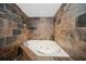 Cozy jacuzzi tub surrounded by stunning slate tiling, perfect for relaxation at 690 Osceola Ave # 604, Winter Park, FL 32789