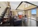 Living room boasts vaulted ceilings, dark floors, and a balcony overlooking the lake at 690 Osceola Ave # 604, Winter Park, FL 32789