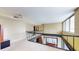 Loft featuring a large open space with railings, large windows, and overhead lighting at 690 Osceola Ave # 604, Winter Park, FL 32789
