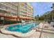 Outdoor pool with chairs, a lush building exterior with patios, and a serene setting for relaxation at 690 Osceola Ave # 604, Winter Park, FL 32789