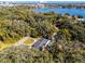 Aerial view of a single story home, large backyard, and circular driveway near a lake at 718 32Nd St, Orlando, FL 32806