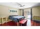 Main bedroom with wood floors, sliding glass doors to patio, and ceiling fan at 718 32Nd St, Orlando, FL 32806