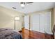 Bedroom with wood floors, large closet, and an adjacent bathroom at 718 32Nd St, Orlando, FL 32806