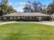 Ranch-style home with a large lawn and attached garage at 718 32Nd St, Orlando, FL 32806