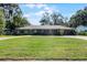 House exterior showcasing a spacious lawn and a two-car garage at 718 32Nd St, Orlando, FL 32806