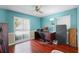 Home office with wood floors, desk, chair, and large window at 718 32Nd St, Orlando, FL 32806