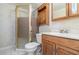 This bathroom features a walk-in shower with glass doors, and traditional oak vanity and matching medicine cabinet at 7340 Daniel Webster Dr # 7, Winter Park, FL 32792