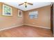 This bedroom has laminate flooring, a ceiling fan, and window with blinds at 7340 Daniel Webster Dr # 7, Winter Park, FL 32792