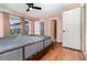 Bedroom with hardwood floors, neutral paint, and a sliding glass door to the outdoors at 7340 Daniel Webster Dr # 7, Winter Park, FL 32792