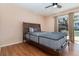 Cozy bedroom with wood-look floors and lots of natural light from the large window at 7340 Daniel Webster Dr # 7, Winter Park, FL 32792