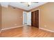 Bedroom featuring laminate floors and a closet with sliding wood doors at 7340 Daniel Webster Dr # 7, Winter Park, FL 32792