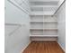 Spacious walk-in closet with built-in shelving and laminate flooring at 7340 Daniel Webster Dr # 7, Winter Park, FL 32792