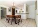 Light and airy dining room with a decorative mirror and tile floors at 7340 Daniel Webster Dr # 7, Winter Park, FL 32792