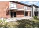 Exterior shot of a brick condo with a patio area and sliding glass doors leading inside at 7340 Daniel Webster Dr # 7, Winter Park, FL 32792