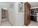 Hallway view leading to bathroom, kitchen, and bedrooms, with tile flooring at 7340 Daniel Webster Dr # 7, Winter Park, FL 32792