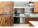 Kitchen featuring wood cabinets, stainless steel appliances, and a window above the sink at 7340 Daniel Webster Dr # 7, Winter Park, FL 32792