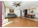 Open concept living room features wood-look floors and a large window with natural light at 7340 Daniel Webster Dr # 7, Winter Park, FL 32792