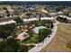 Aerial view of community pool, landscaping, and building at 7521 Mourning Dove Cir # 303, Reunion, FL 34747