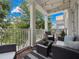 Spacious balcony boasting wicker furniture and a tranquil view at 7521 Mourning Dove Cir # 303, Reunion, FL 34747