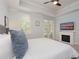 Serene bedroom with a king-size bed, fireplace and balcony access at 7521 Mourning Dove Cir # 303, Reunion, FL 34747