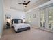 Relaxing bedroom with a comfortable bed and access to a private balcony at 7521 Mourning Dove Cir # 303, Reunion, FL 34747