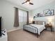 Bright bedroom with a comfortable bed, window coverings, and wall art at 7521 Mourning Dove Cir # 303, Reunion, FL 34747