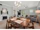 Open concept dining and living area with modern furniture at 7521 Mourning Dove Cir # 303, Reunion, FL 34747