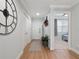 Light and bright entryway with wood floors and a view of a bedroom at 7521 Mourning Dove Cir # 303, Reunion, FL 34747