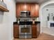 Stainless steel appliances and wood cabinets in a modern kitchen at 7521 Mourning Dove Cir # 303, Reunion, FL 34747
