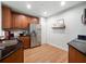 Modern kitchen with stainless steel appliances and wood cabinets at 7521 Mourning Dove Cir # 303, Reunion, FL 34747