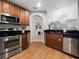 Modern kitchen with stainless steel appliances and wood cabinets at 7521 Mourning Dove Cir # 303, Reunion, FL 34747