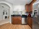 Stainless steel appliances and wood cabinets in a modern kitchen at 7521 Mourning Dove Cir # 303, Reunion, FL 34747