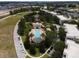 Community pool with surrounding landscaping and seating areas at 7521 Mourning Dove Cir # 303, Reunion, FL 34747