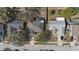 An aerial view showcasing the neighborhood, rooflines, yards, and surrounding trees at 1001 Willow Run St., Minneola, FL 34715