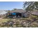 The backyard features a screened-in patio and a storage shed surrounded by a chain link fence at 1001 Willow Run St., Minneola, FL 34715