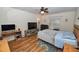 Inviting bedroom features wood flooring, a comfortable bed, and a relaxing atmosphere at 1001 Willow Run St., Minneola, FL 34715