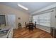 Bright breakfast nook features a round dining table, hardwood floors, and view of adjacent kitchen at 1001 Willow Run St., Minneola, FL 34715