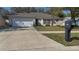 Single story home with well-manicured lawn, visible mailbox with the number 1001 at 1001 Willow Run St., Minneola, FL 34715