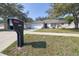 A home with curb appeal is enhanced by a verdant front yard and mailbox at curbside at 1001 Willow Run St., Minneola, FL 34715