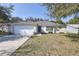 Charming single-story home with a well-manicured lawn and two-car garage at 1001 Willow Run St., Minneola, FL 34715