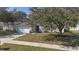 Charming home featuring a well-maintained lawn shaded by a mature tree at 1001 Willow Run St., Minneola, FL 34715