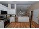 Open concept kitchen with stainless steel appliances, including stove and dishwasher, and white cabinets at 1001 Willow Run St., Minneola, FL 34715