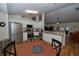 Open kitchen overlooks a cozy dining area, features white cabinets, stainless appliances, and wood flooring at 1001 Willow Run St., Minneola, FL 34715