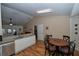 Open concept kitchen flows into dining area, features wood floors, stainless steel appliances and breakfast bar at 1001 Willow Run St., Minneola, FL 34715