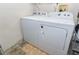 Functional laundry room with a full-size washer and dryer and tiled floors for convenience at 1001 Willow Run St., Minneola, FL 34715