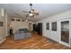 A spacious living room featuring hardwood floors, ceiling fans, and plenty of natural light at 1001 Willow Run St., Minneola, FL 34715