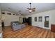A spacious living room featuring hardwood floors, ceiling fans, and plenty of natural light at 1001 Willow Run St., Minneola, FL 34715