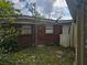 Brick house exterior with damaged siding at 1040 Maxey Dr, Winter Garden, FL 34787